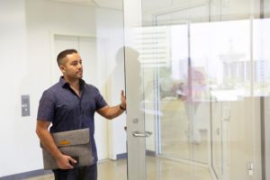 man near glass door